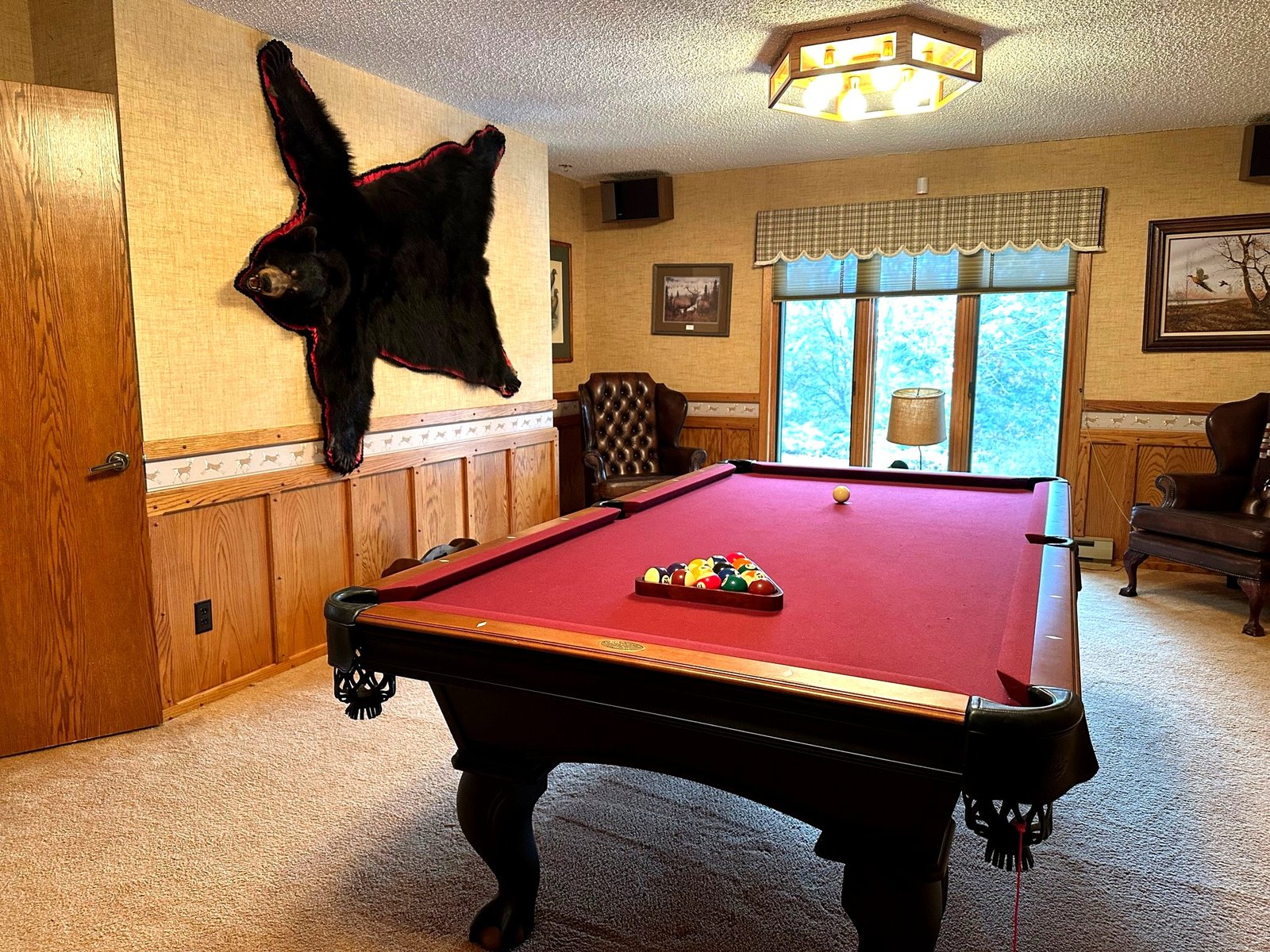 Billiards room with pool table at Eagle's Bluff luxury estate on Flathead Lake, Montana