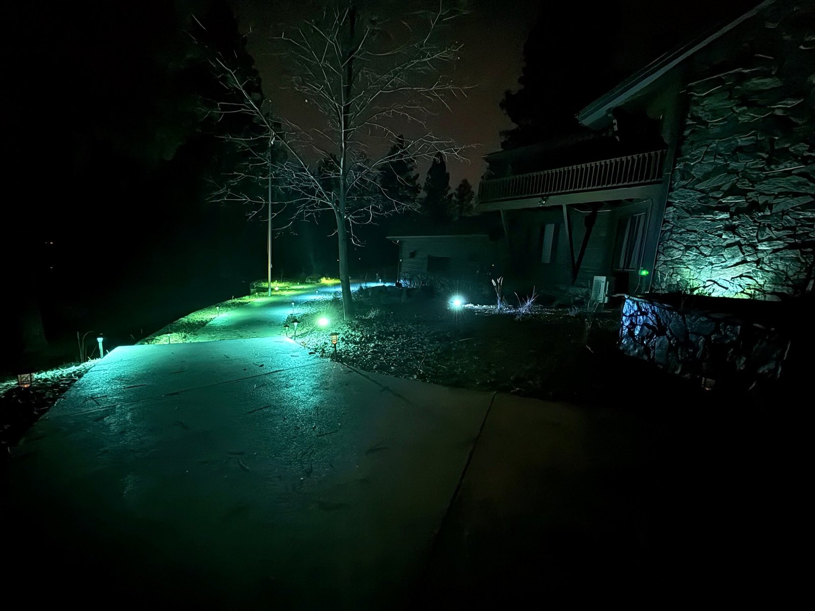 Illuminated walkway at Eagle's Bluff luxury estate at night