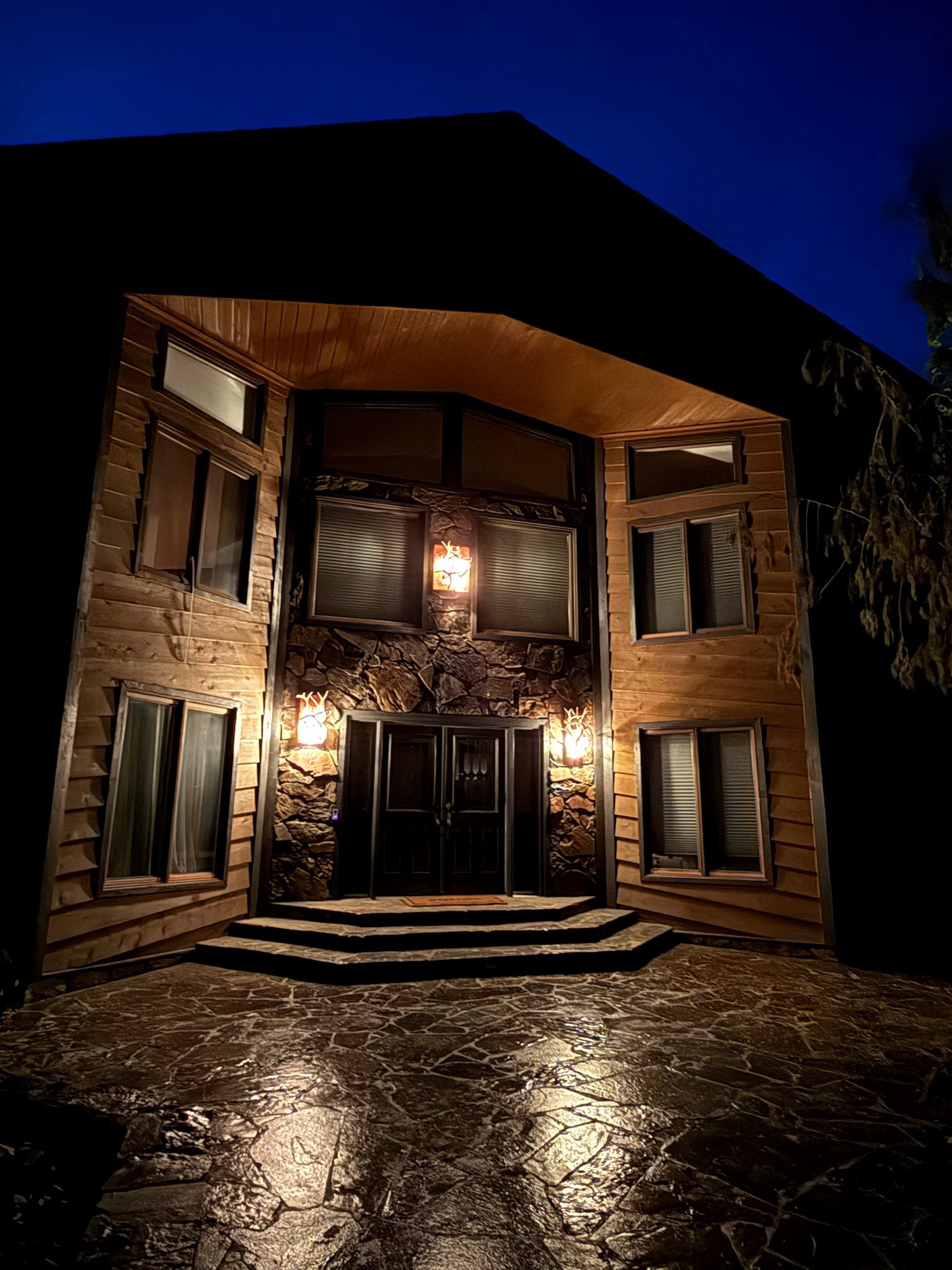 Eagle's Bluff Main House illuminated at night on Flathead Lake