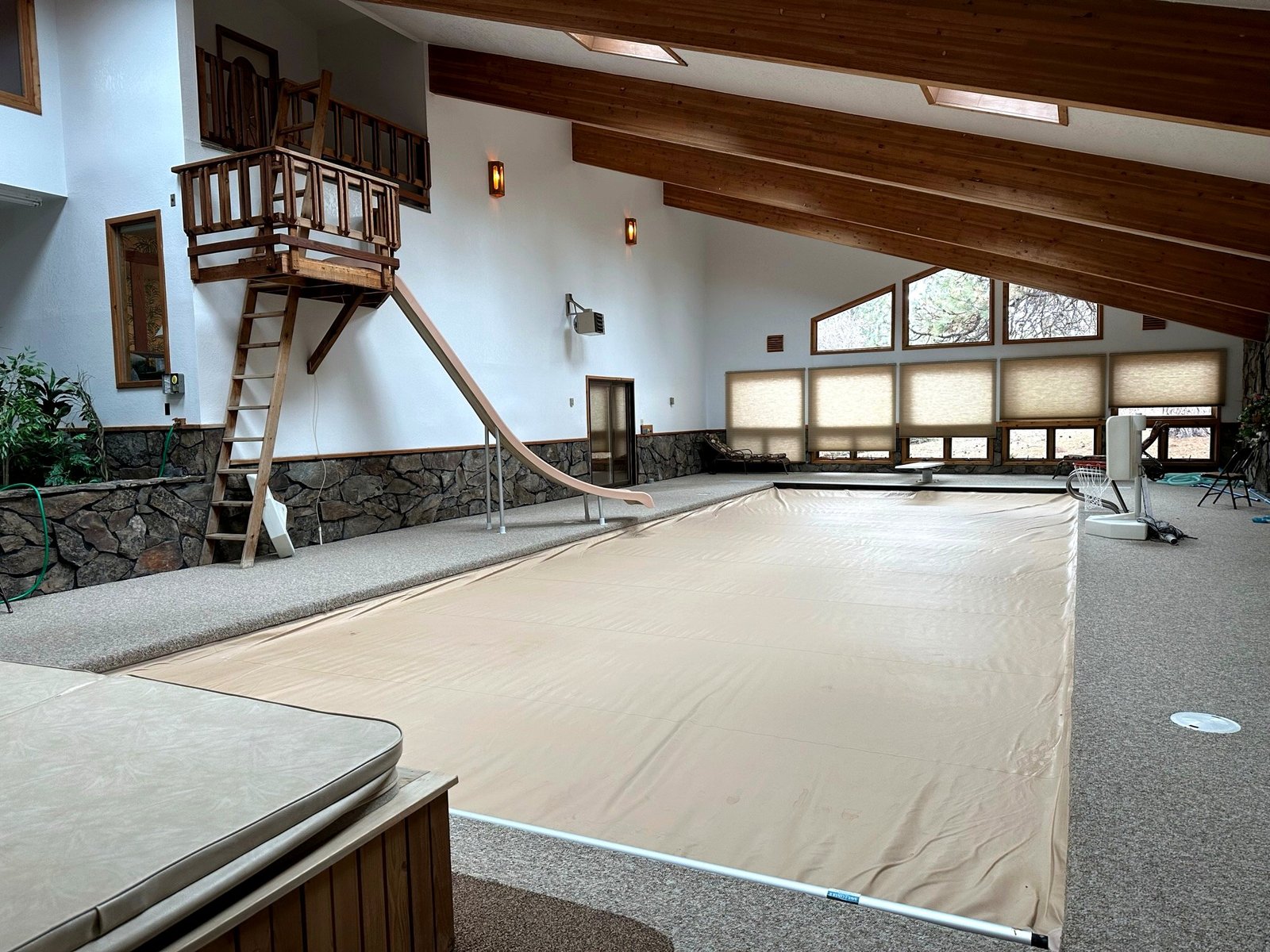 Indoor pool with waterslide and diving board at Eagle's Bluff luxury estate on Flathead Lake