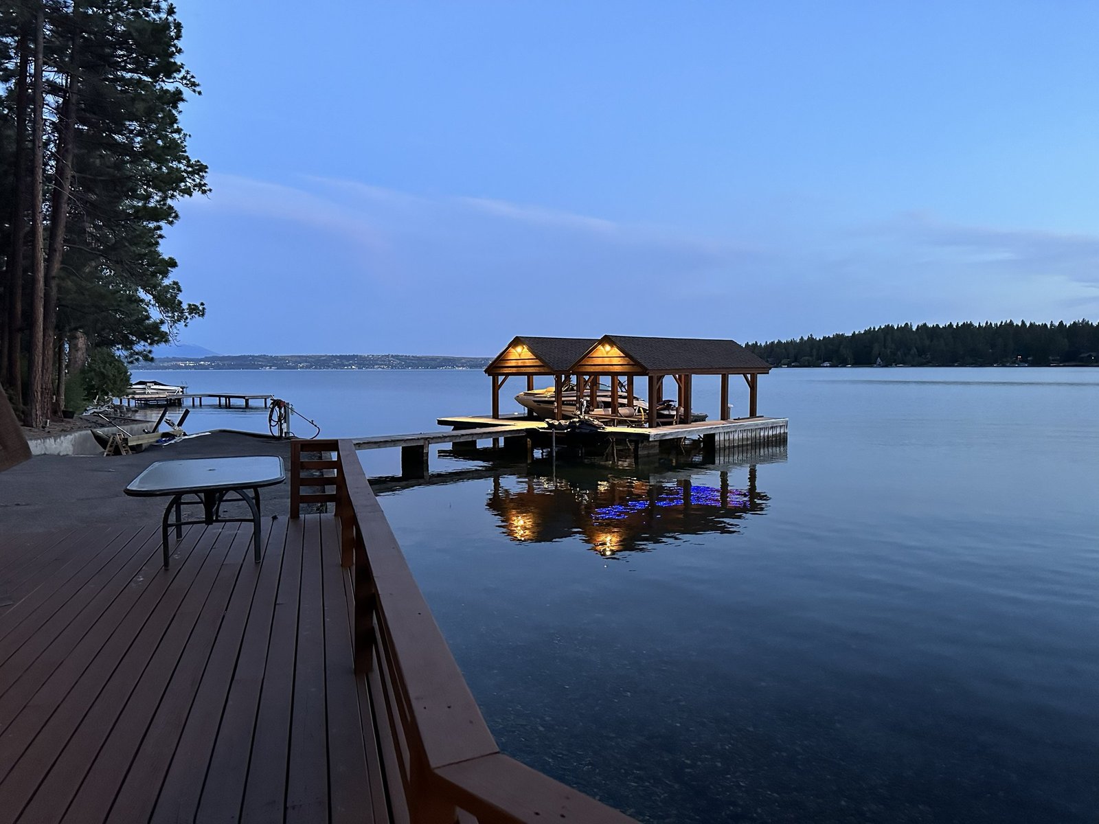 Private boat dock with covered slips and jet ski lifts at Eagle's Bluff on Flathead Lake