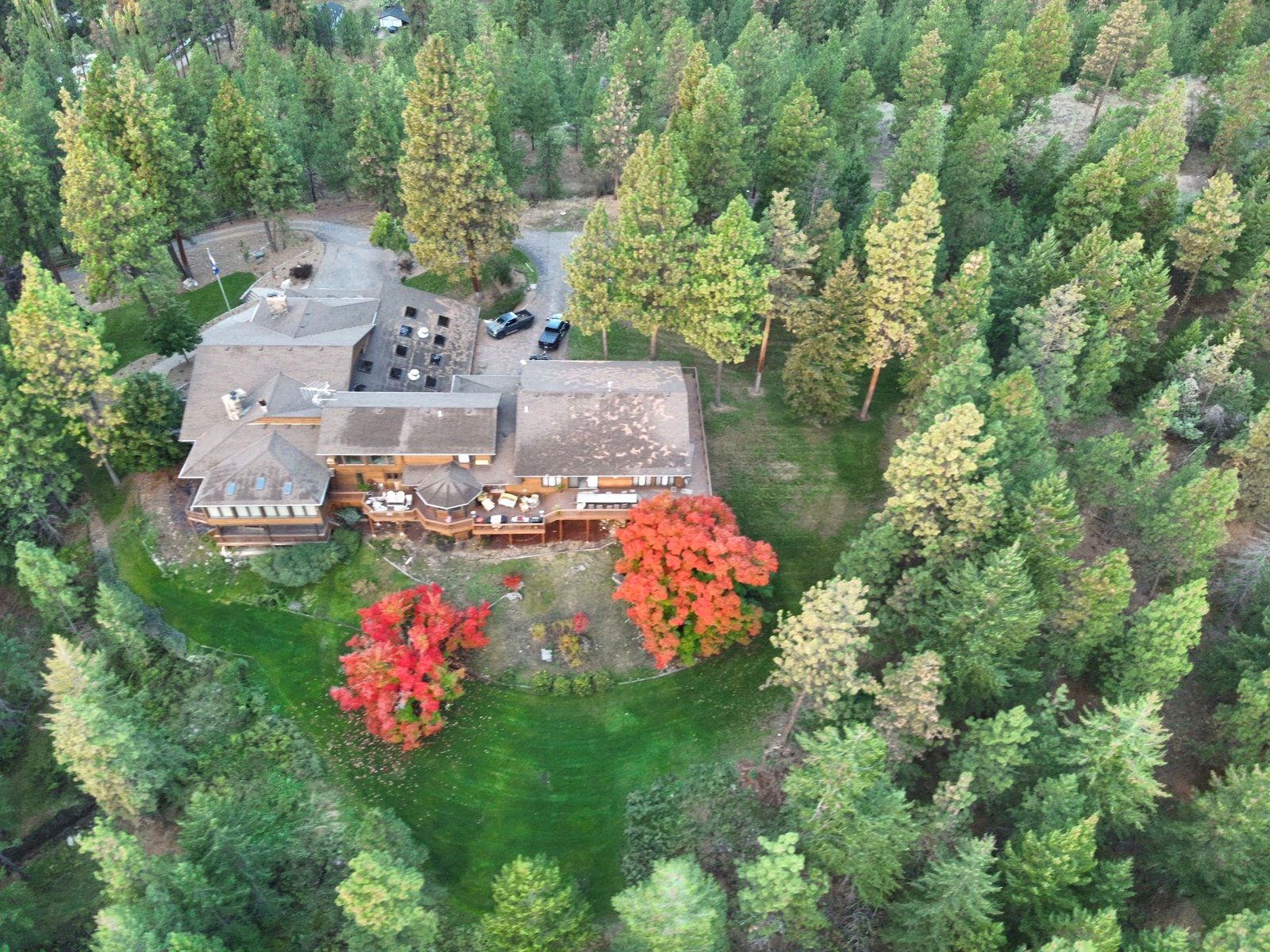 Autumn panorama of Eagle's Bluff Main House with Flathead Lake and Mission Mountains